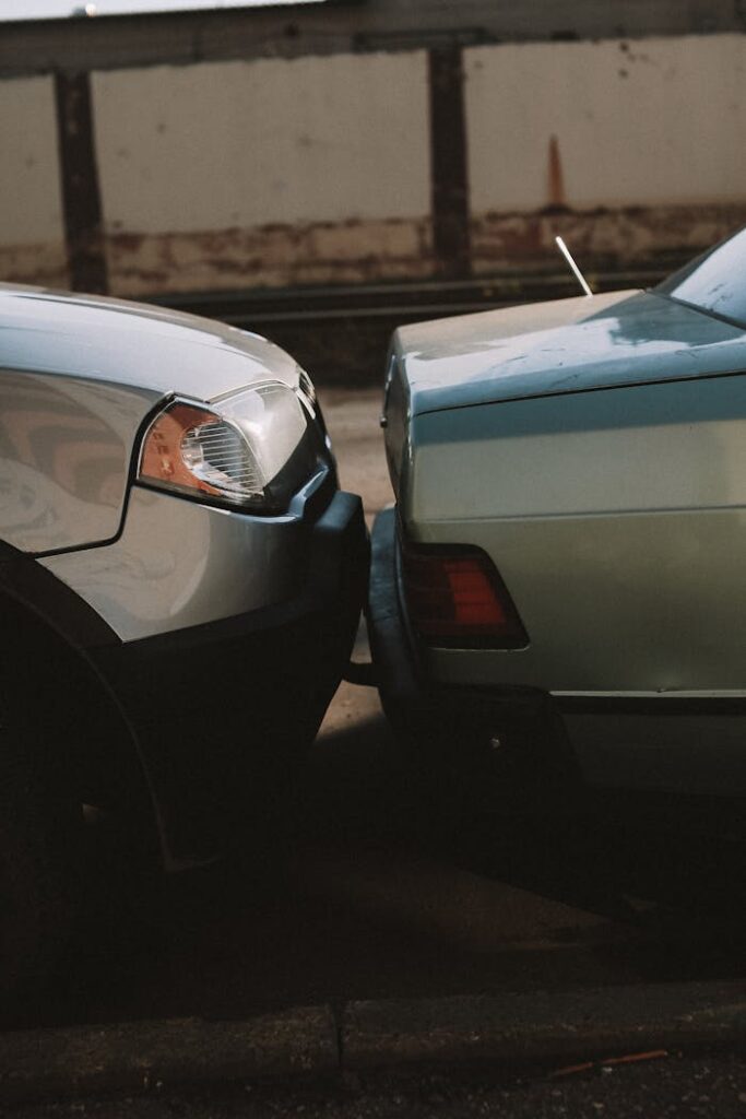 pexels-photo-10102313 A close-up view showing the aftermath of a rear-end car collision in an outdoor setting.